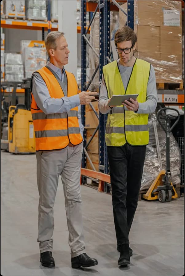 Manufacturing team checking inventory billing records in a warehouse